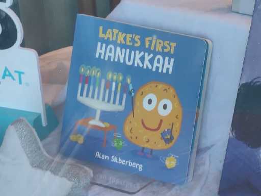 latke's first hanukkah, a crudely illustrated book with cardboard pages presumably intended for children